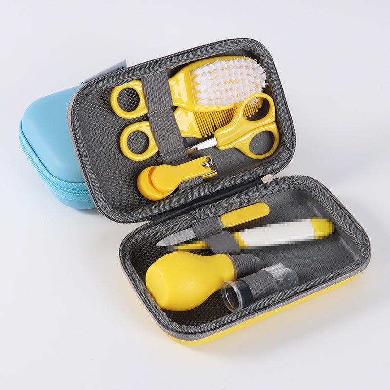 Yellow baby grooming kit with scissors, brush, comb, nasal aspirator, nail clippers, and file in a travel case