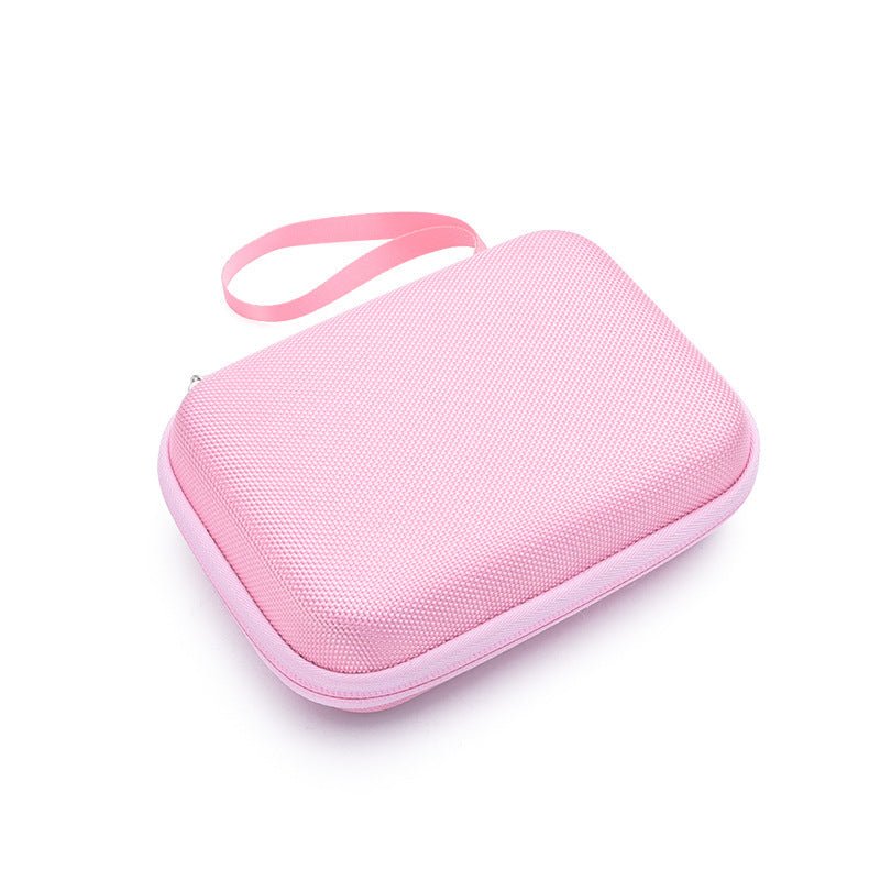 Pink zippered travel case for baby grooming kit with wrist strap on white background