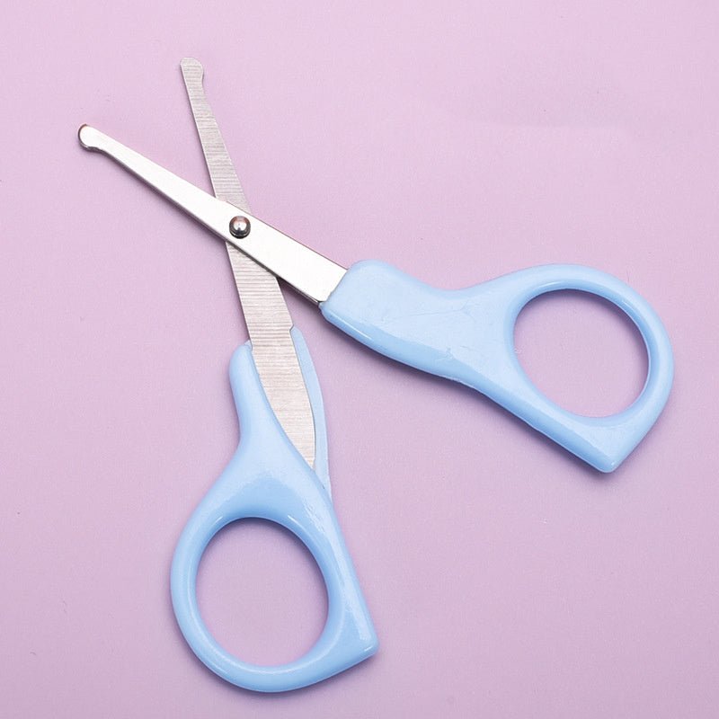 Blue baby nail scissors with rounded safety tips on a pink background