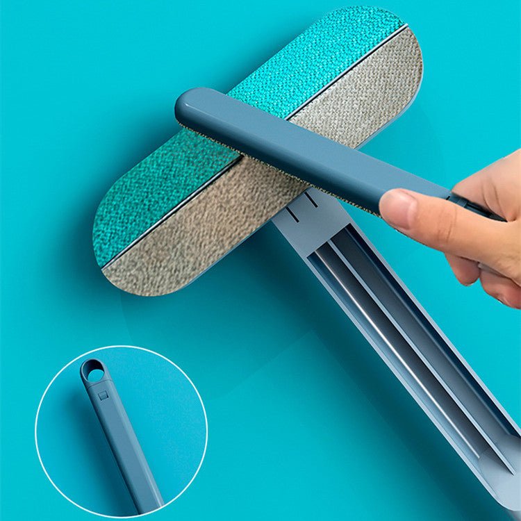 Close-up of dual-sided pet hair removal brush with cleaning tool