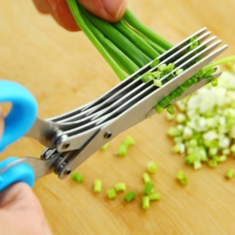 Multi-layer herb scissors with blue handle cutting green onions on wooden board