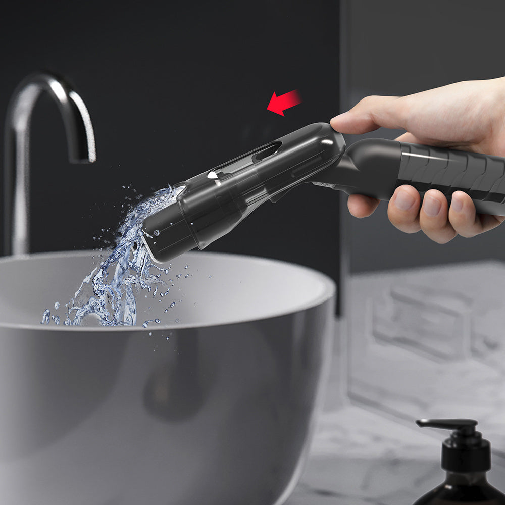 Rinsing the mini spray mop sponge head under running water in the sink