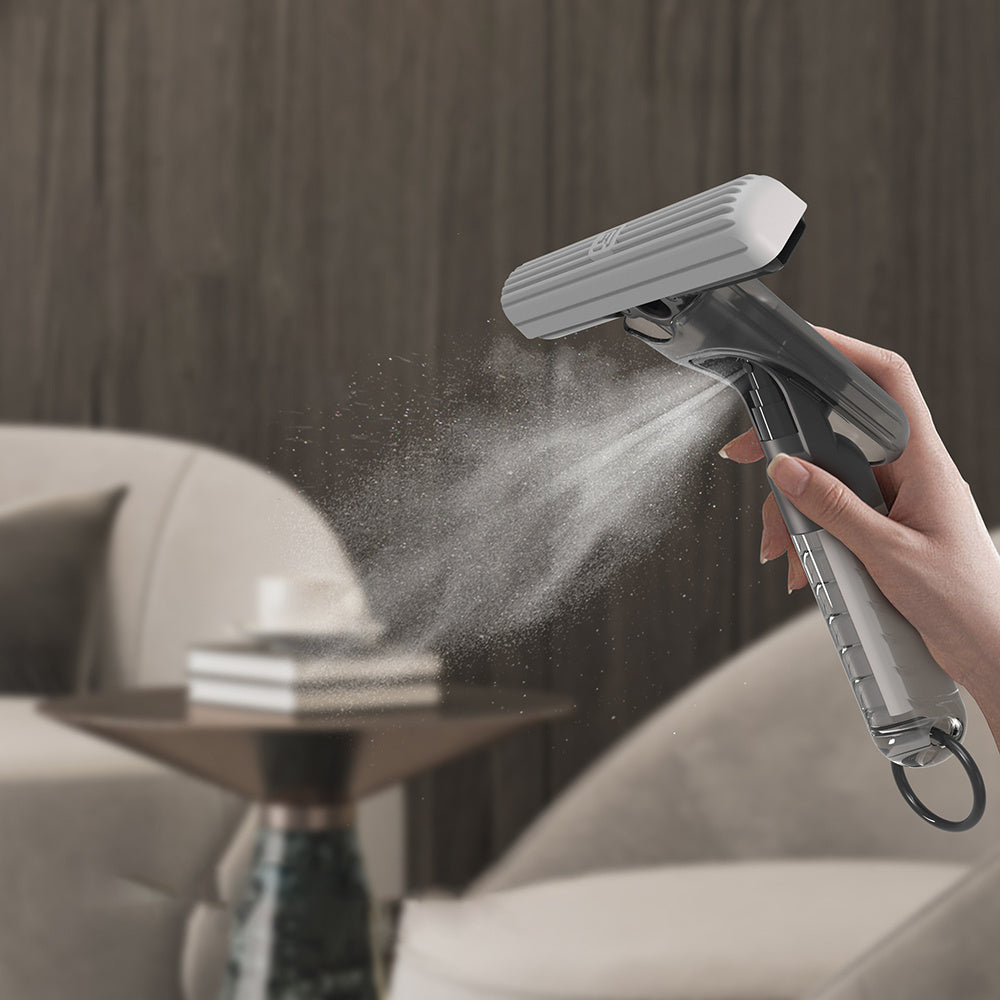 Mini spray mop releasing fine mist of cleaning solution onto surface