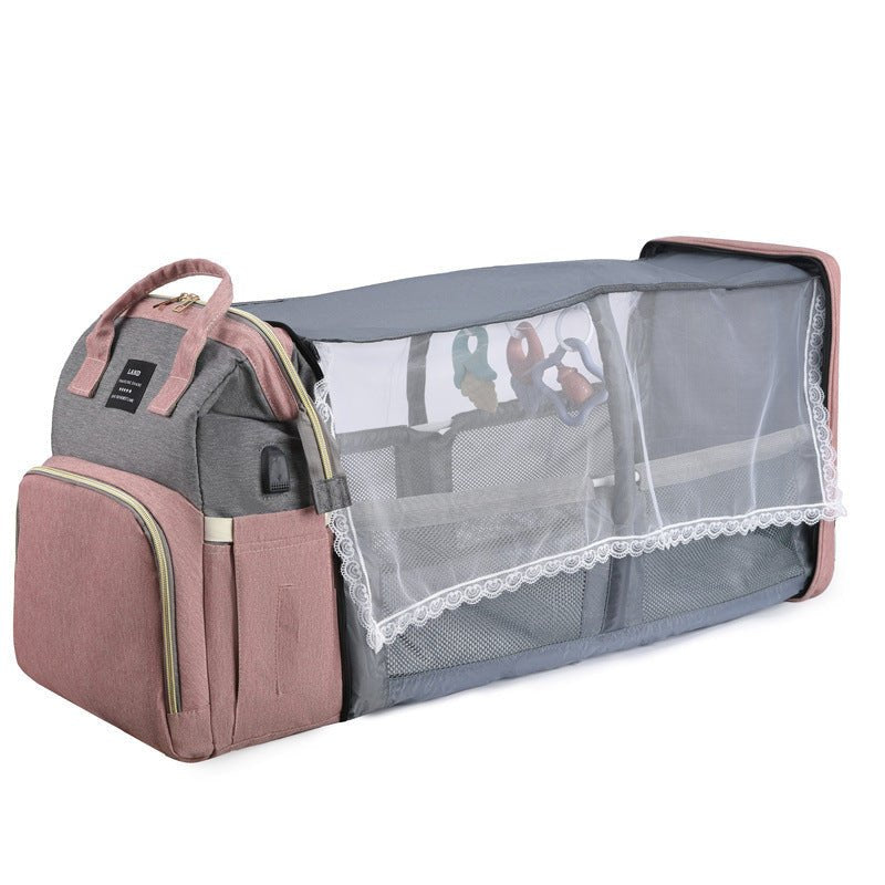 Foldable mummy baby crib backpack with mosquito net and hanging toys