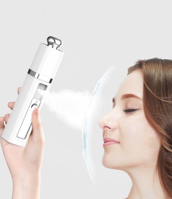 Woman using a white nano facial mist sprayer for skincare hydration