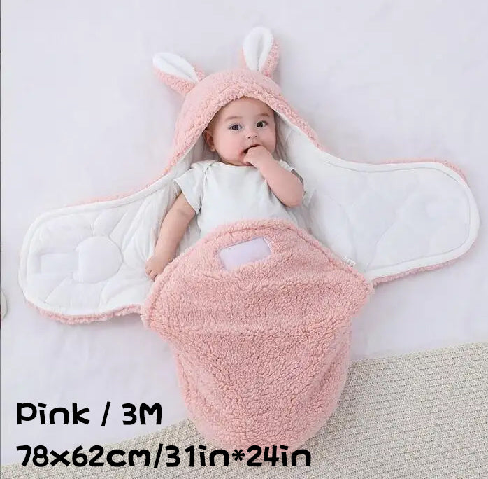 Baby in a pink fluffy swaddle sleeping bag with bunny ears, labeled "Pink / 3M 78×62cm/31in*24in".