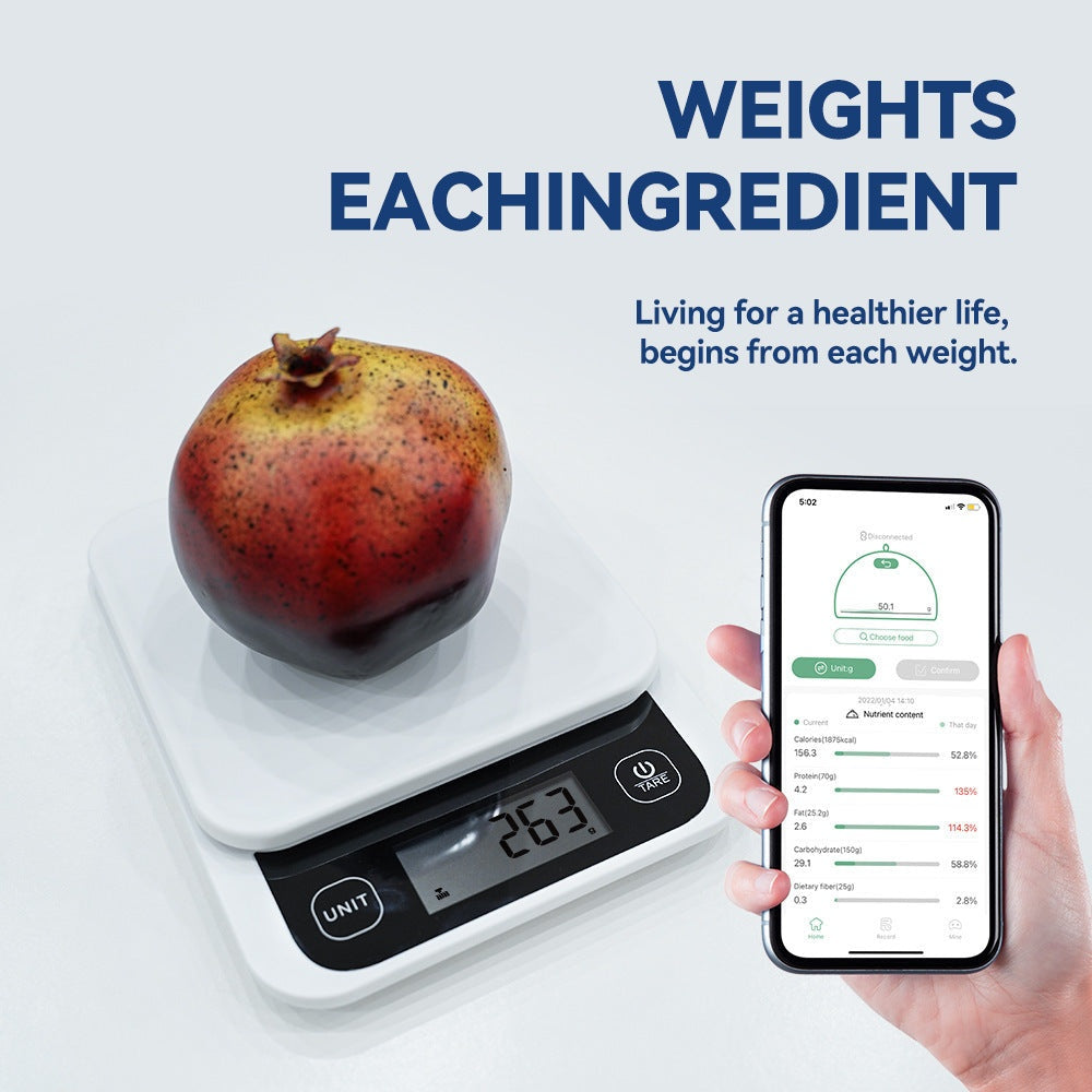 Smart kitchen scale measuring a pomegranate, with a connected app displaying nutritional information on a smartphone.