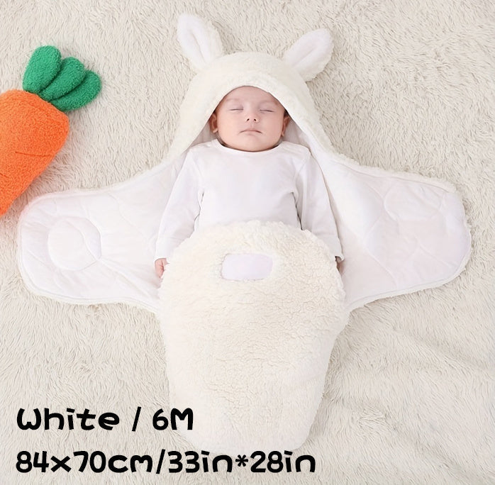 Baby in white swaddle blanket with bunny ears, size 6M (84x70cm / 33in x 28in).
