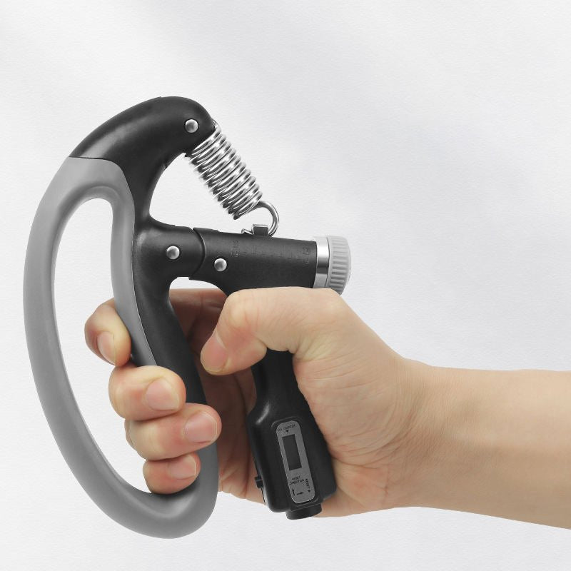 Hand holding a black adjustable grip strengthener with digital counter, demonstrating its ergonomic design and usage.
