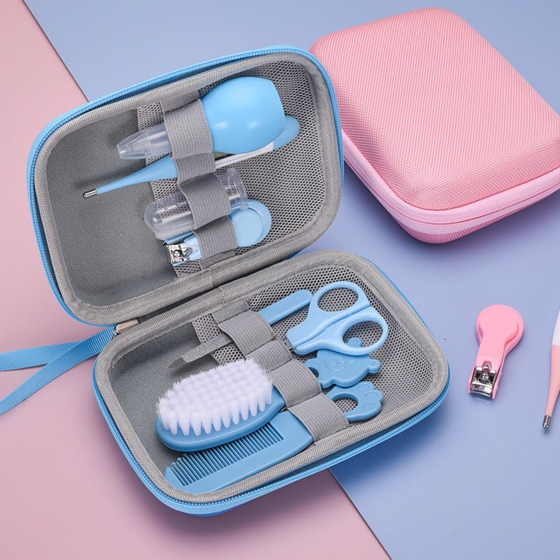 8-piece baby grooming and healthcare kit in a blue travel case with scissors, brush, thermometer, and more on soft pink and blue background
