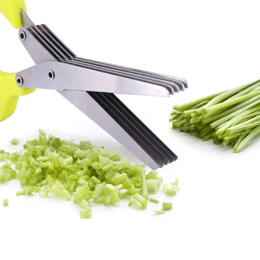 Multi-layer herb scissors with green handle chopping fresh chives on white background