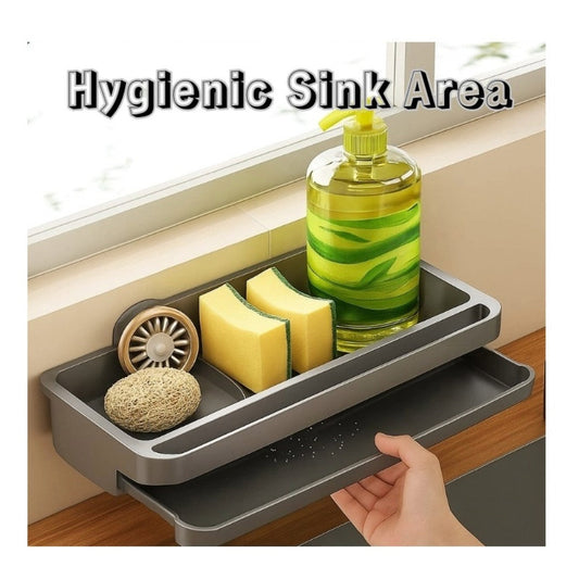 Clean kitchen sink area with organized sponges and soap on a hygienic drain rack.