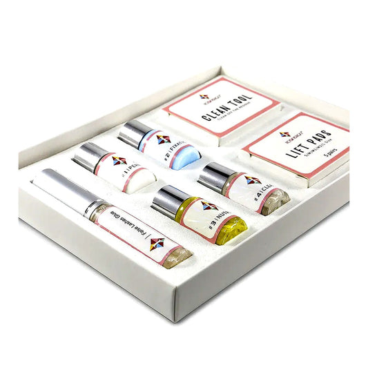 Angled view of a complete at-home lash lift kit with lifting lotions, glue, tools, and accessories, displayed in an open box on a clean white background.
