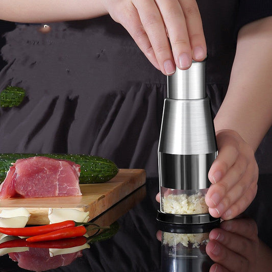Woman preparing food with a manual garlic and onion press for quick and tear-free chopping.