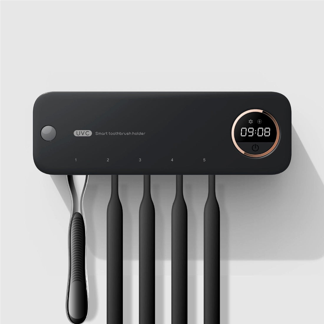 Wall-mounted black smart toothbrush holder with digital display and UVC sterilization feature, holding five toothbrushes in a modern minimalist bathroom setup.