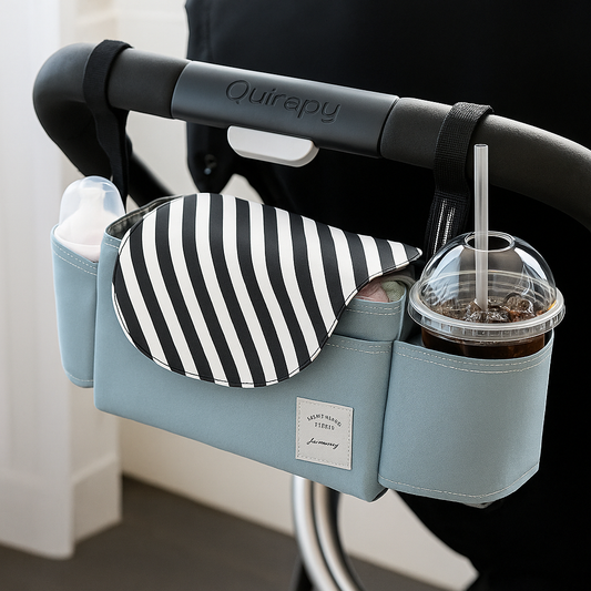 Baby stroller organizer attached to a stroller handle, showing practical use in a modern setting.