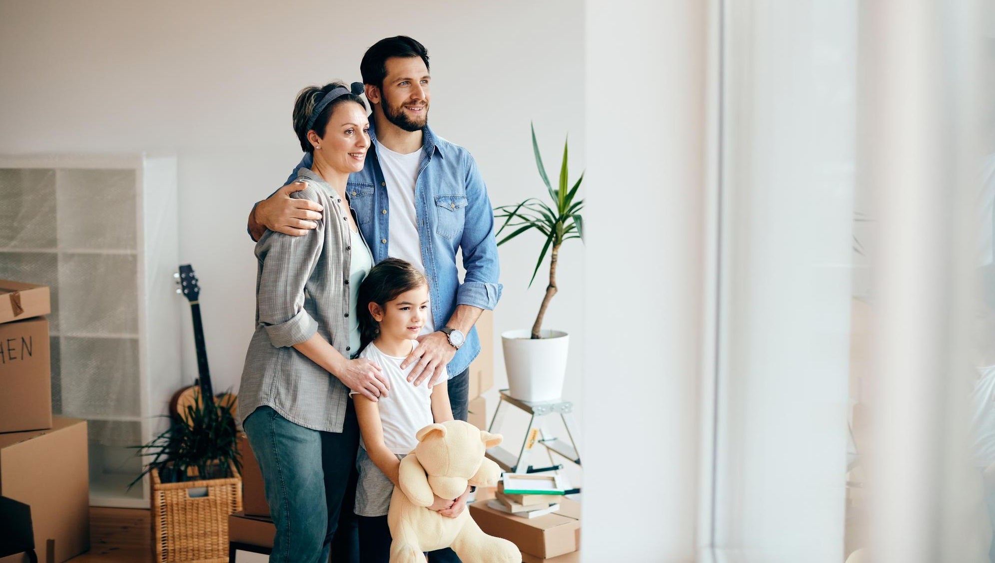 Smiling family in a bright modern home, representing the comfort, warmth, and care behind HiveCart's home essentials.