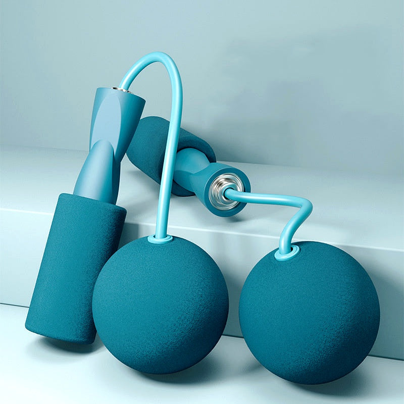 Adjustable blue jump rope set with weighted balls and foam grips, laid flat on a soft blue surface.