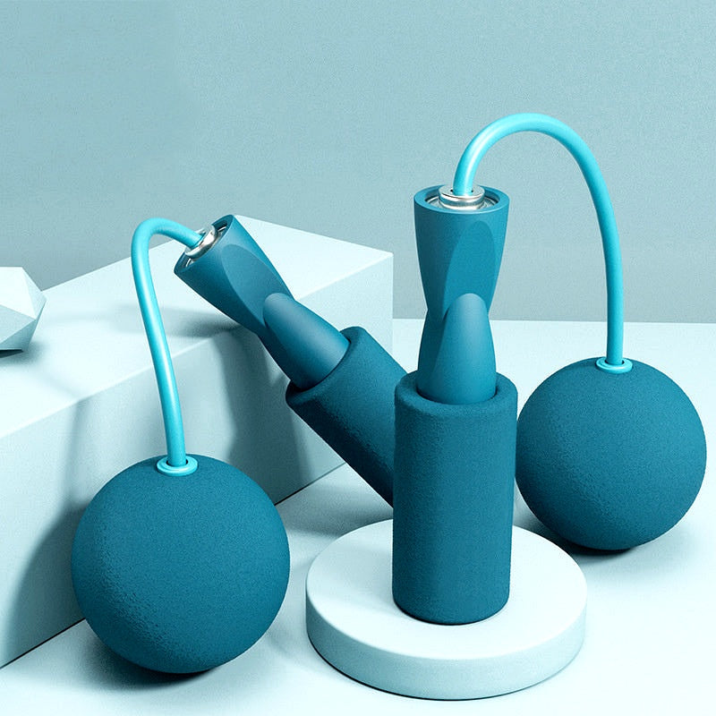 Cordless weighted jump rope set displayed upright on a round base, showcasing foam handles and compact design.