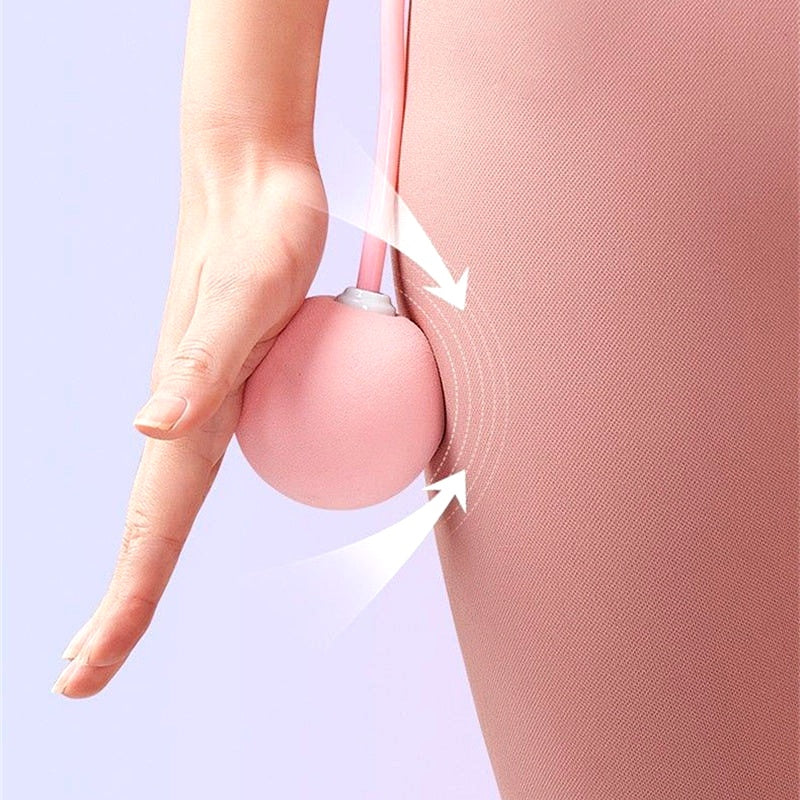 Close-up of a pink weighted jump rope ball in use during a workout, shown near the hip for demonstration.
