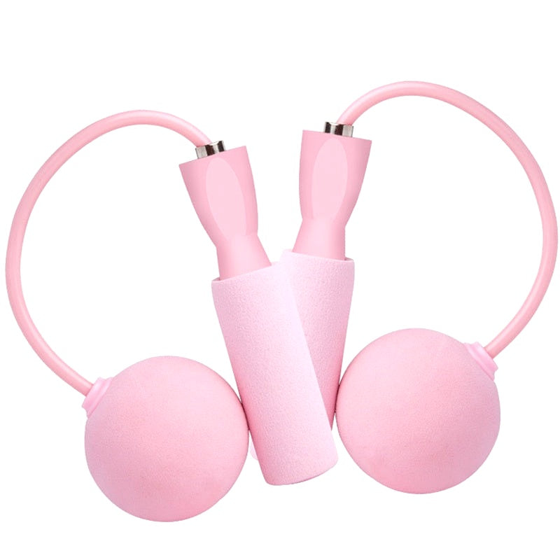 Isolated image of a pink cordless weighted jump rope set with foam handles and spherical weights on a white background.