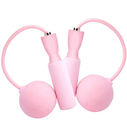 Isolated image of a pink cordless weighted jump rope set with foam handles and spherical weights on a white background.