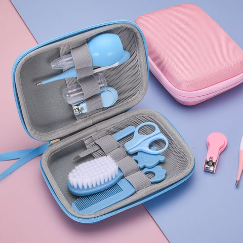 Blue baby grooming kit with nail clippers, scissors, brush, comb, and nasal aspirator in a zippered travel case