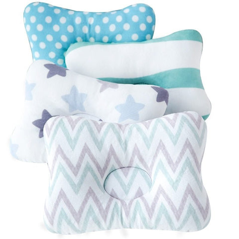 Set of four pillows with different patterns on a white background