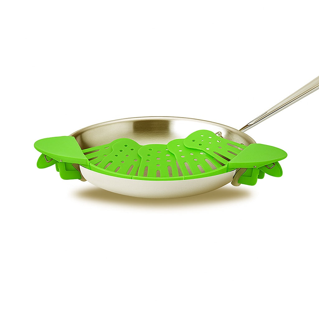 Green clip-on strainer attached to a stainless steel frying pan, displayed on a clean white background.
