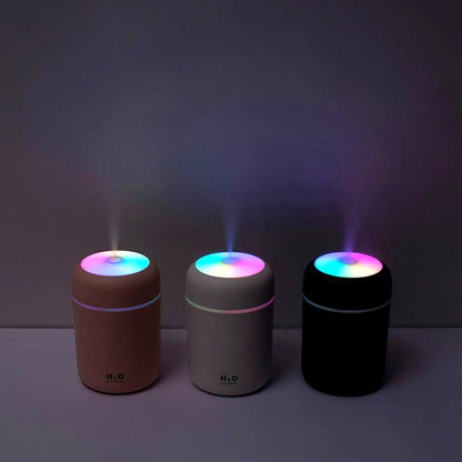 Three Color Cup USB Air Humidifiers in the dark with colorful LED lights and mist