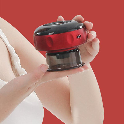 Electric cupping massager with red light held in hand against red background