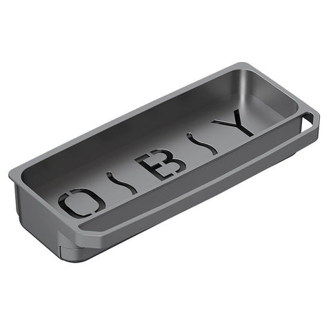 Close-up of an empty dark gray kitchen sink organizer tray with cut-out lettering in the base