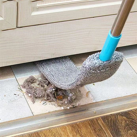 Flat microfiber dust mop cleaning under cabinet, removing dust and debris