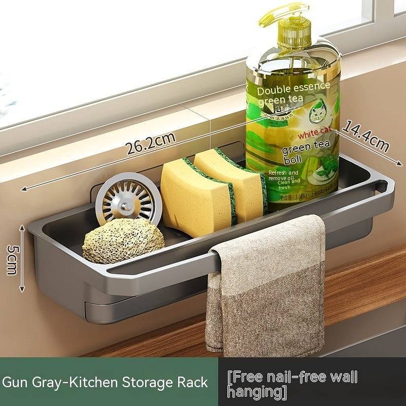 Gun gray kitchen storage rack with labeled dimensions and items like sponges, dish soap, and towel, mounted above a wooden countertop