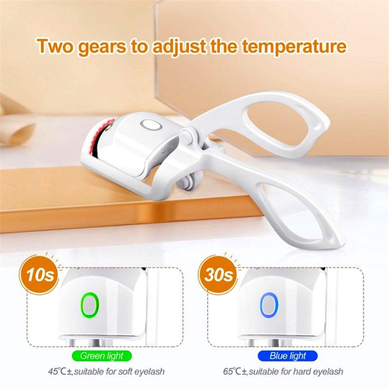 Heated eyelash curler showing two temperature modes: green light for soft lashes and blue light for hard lashes
