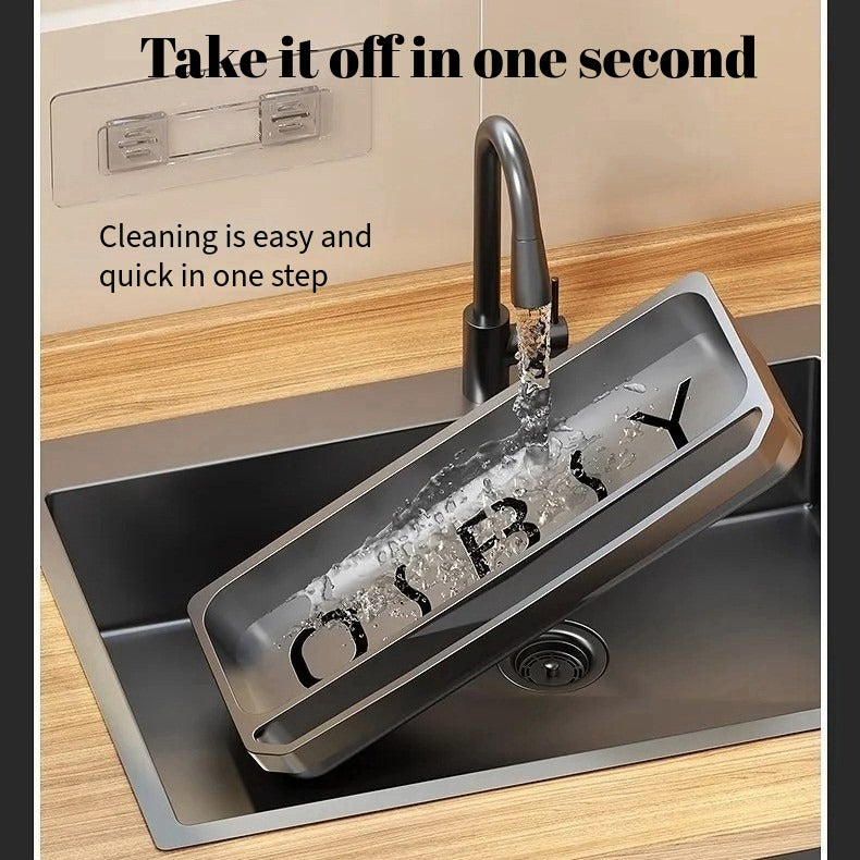 Kitchen sink storage rack being rinsed under running water to show easy cleaning design.