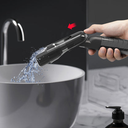 Rinsing the mini spray mop sponge head under running water in the sink