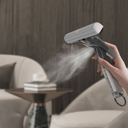 Mini spray mop releasing fine mist of cleaning solution onto surface