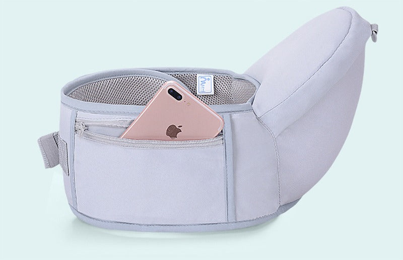 Close-up of waist stool storage pocket on baby carrier with phone inside – practical for parents on the go