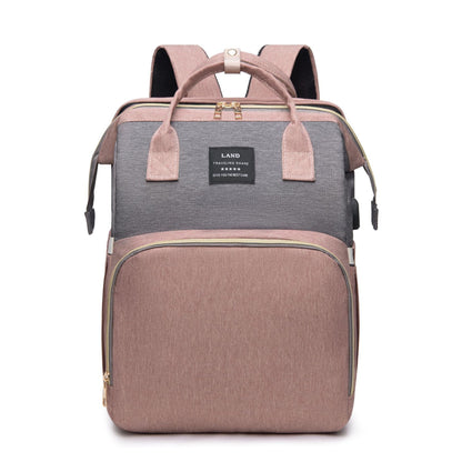 Mummy baby crib backpack in pink and gray color with spacious front pocket and dual handles