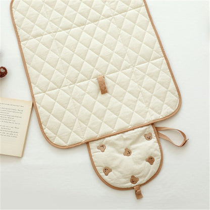 Portable baby changing pad with bear pattern, open view showing quilted cotton surface