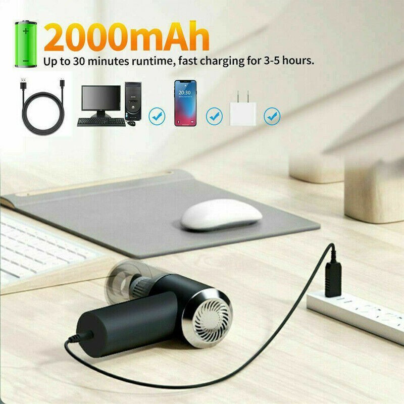 Portable car vacuum cleaner charging via USB cable on a wooden desk, highlighting 2000mAh battery capacity and 30-minute runtime