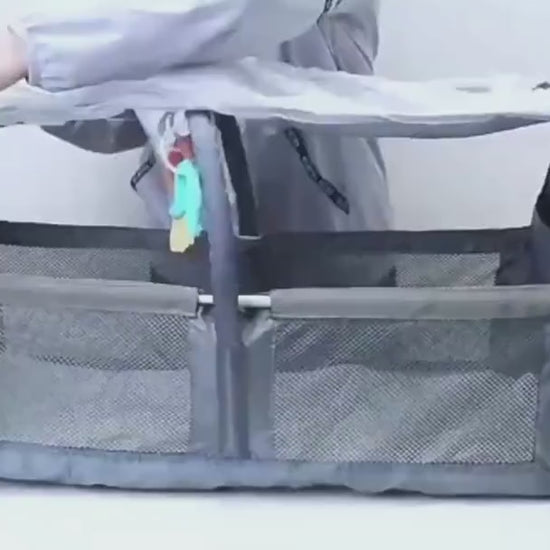 Product video of the Mummy Baby Crib Backpack showing how it unfolds into a portable crib and highlights the insulated bottle holders