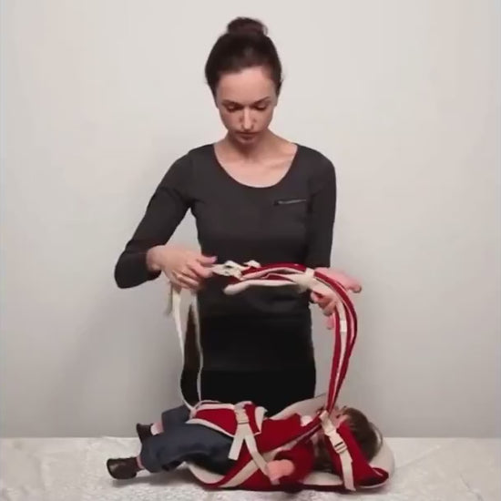 Parent demonstrating the Four Seasons Baby Carrier in different carrying positions for newborns and toddlers