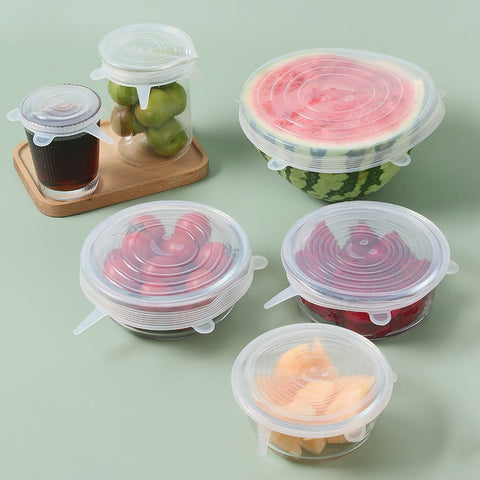 Set of containers with clear silicone elastic lids covering fresh fruits and vegetables