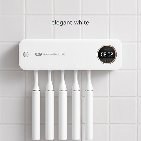 Wall-mounted white smart toothbrush holder with UV sterilizer and digital display, placed on a clean ceramic-tiled bathroom wall.