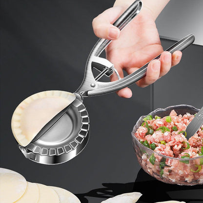 Person using stainless steel dumpling maker to seal dumplings with meat filling