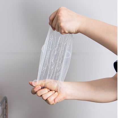Hands stretching a transparent silicone lid to show flexibility