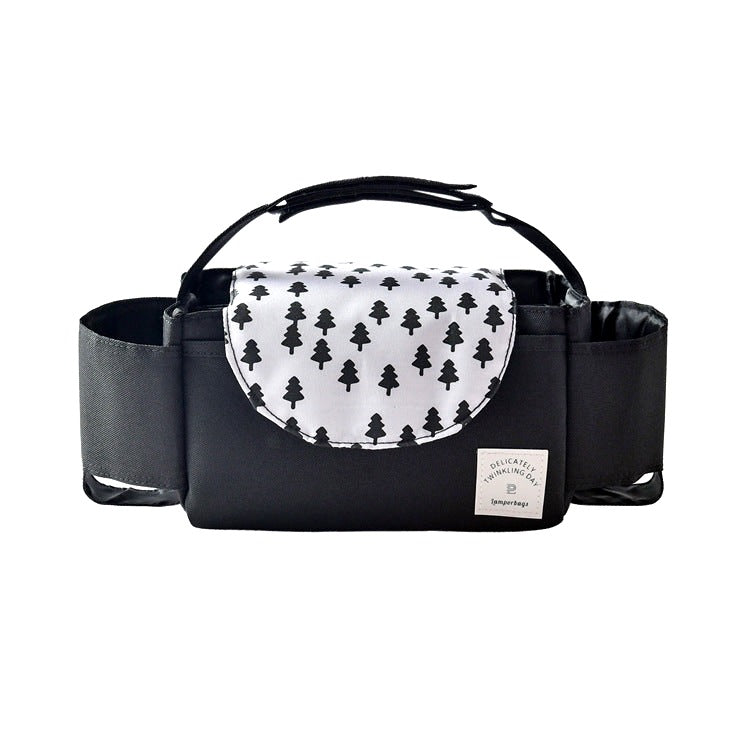 Black stroller organizer bag with a white flap featuring a tree pattern, photographed on a white background, showing cup holders and a central compartment.