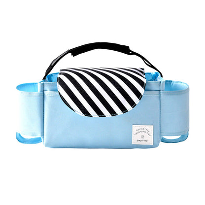 Light blue stroller organizer bag with a black and white striped flap, photographed on a white background, showing compartments for bottles and small items.